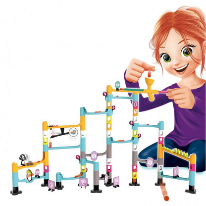 Marble run set with child holding a small builder piece next to the track