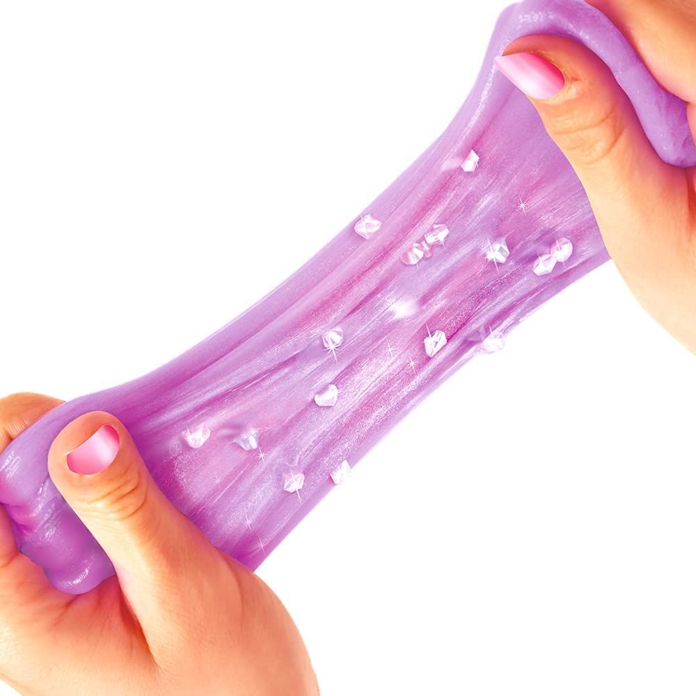 Purple scented slime stretched by hands, with small sparkle pieces visible