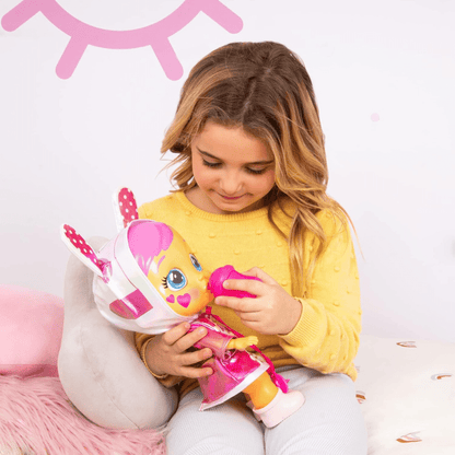 Baby doll with pink bunny hood and yellow sweater top, held with mini accessories