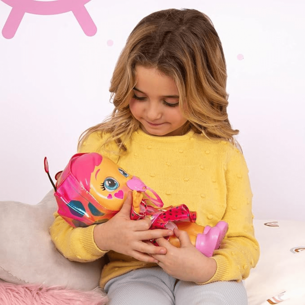 Baby doll with orange face, blue eyes, pink polka-dot dress, held in hands
