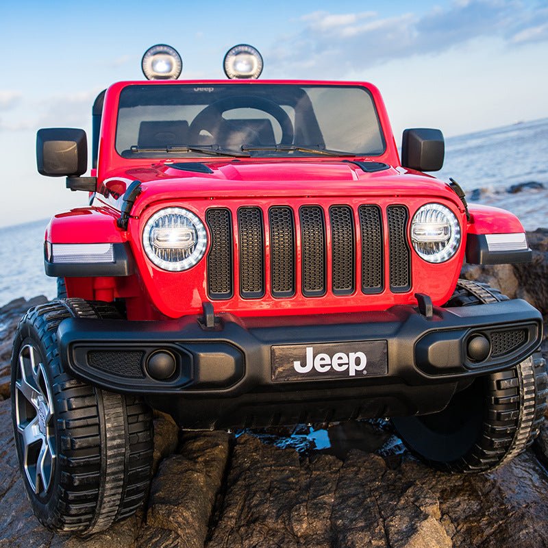 Red Jeep Wrangler Rubicon ride-on car, front view with bumper and fog lights by Dake
