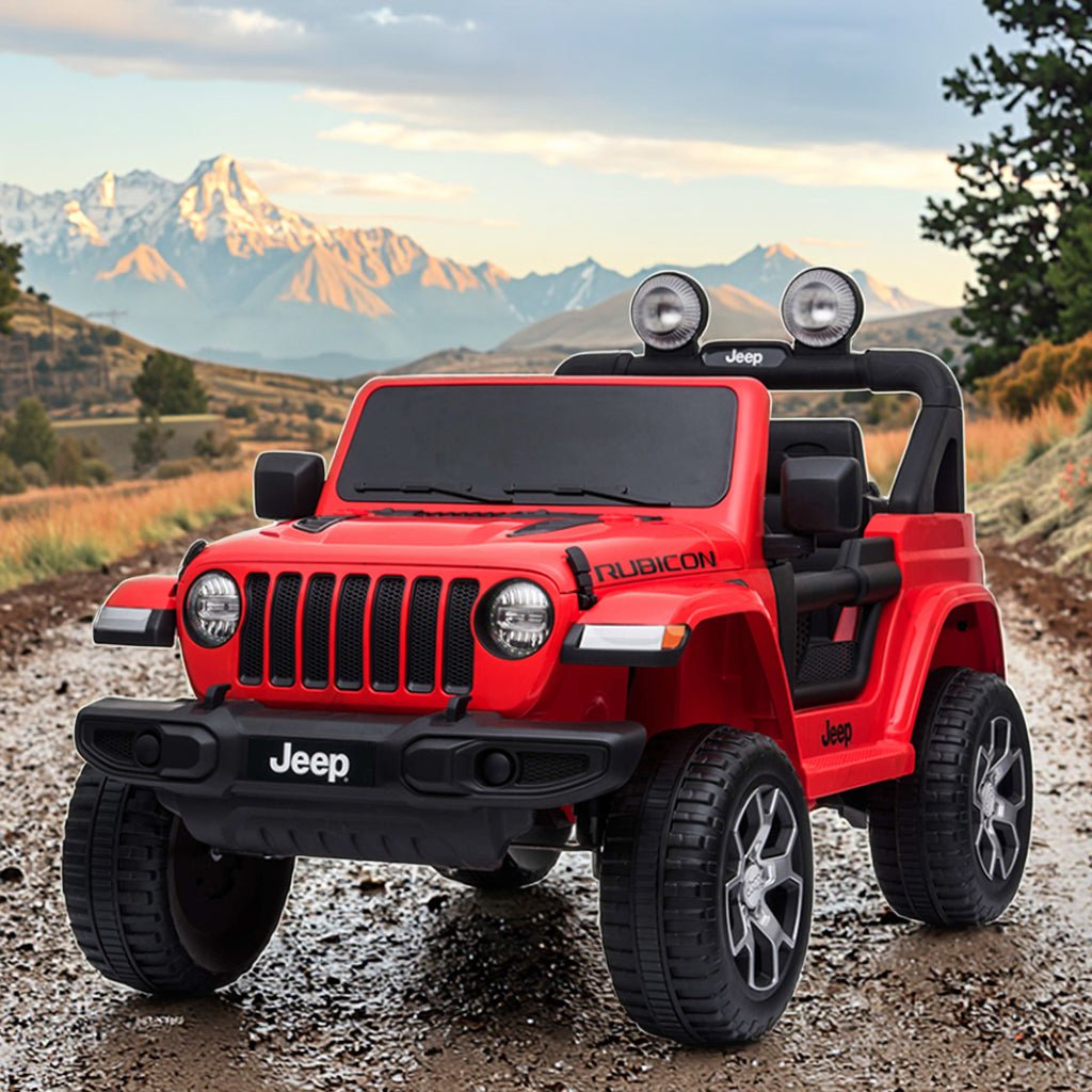 Red Jeep Wrangler Rubicon ride-on car, front three-quarter view with light bar