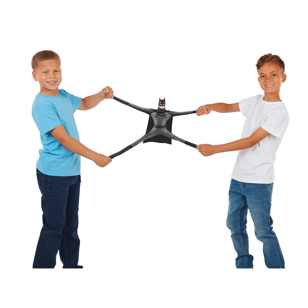Batman stretch figure held between two children, black suit with cape and bat mask