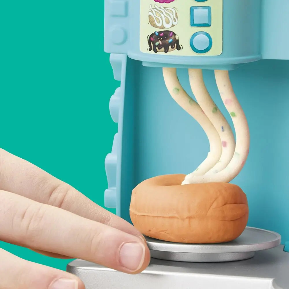 Play-Doh donut drop machine with orange dough piece on the rotating base