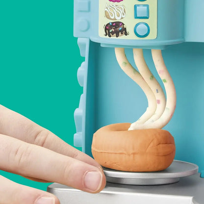 Play-Doh donut drop machine with orange dough piece on the rotating base