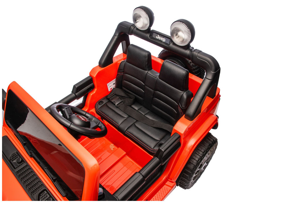 Ride-on interior with black padded seats, steering wheel, and dashboard controls