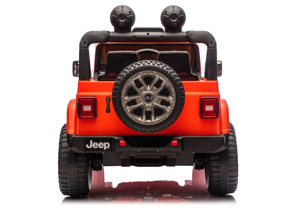 Orange Jeep Rubicon-style ride-on vehicle, rear view with spare tire and tail lights