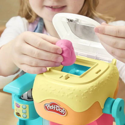 Play-Doh donut drop maker with pink dough piece on the front tray