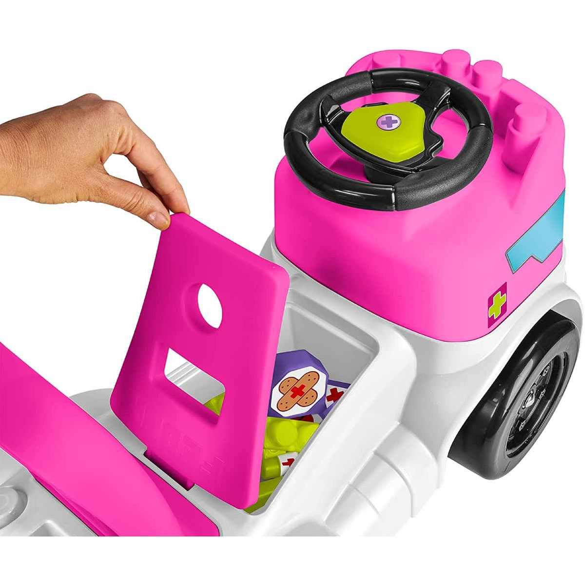 Pink and white ambulance toy vehicle showing open side panel and steering wheel