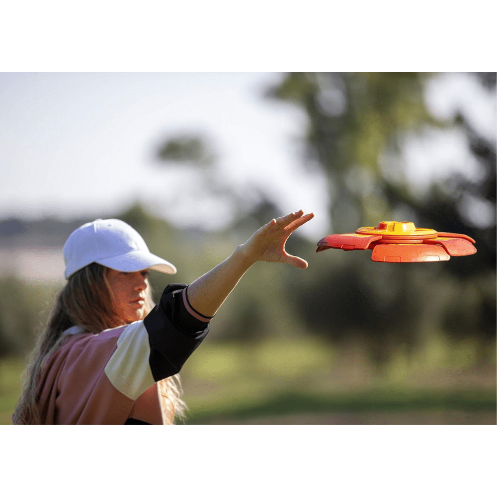 Orange and purple slider disc timer toy launcher being thrown, disc in midair