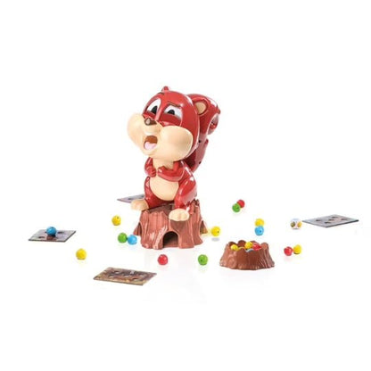 Red character figure with toy cups, cards, and colorful small balls for tabletop game