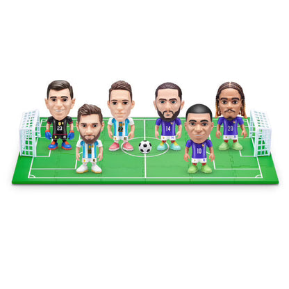 Mini football player figures posed on a soccer field with goal and net