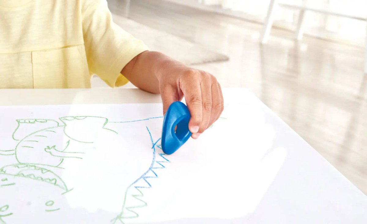 Blue triangular grip crayon with thumb hole drawing on paper