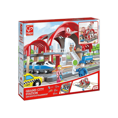 Toy train station playset retail box showing red station arch and toy vehicles