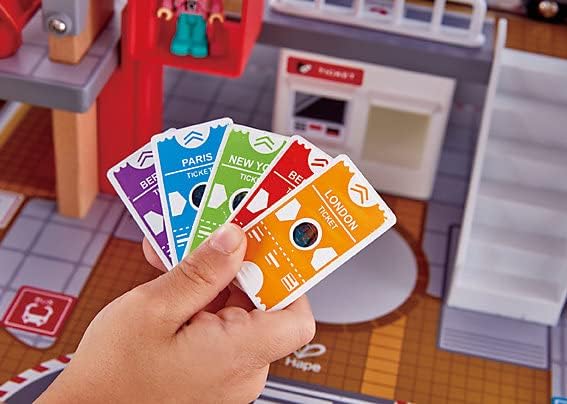 Toy station playset with colorful destination tickets held near the station console