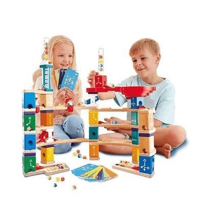 Marble run set with colorful track blocks, plus pieces and marbles on table