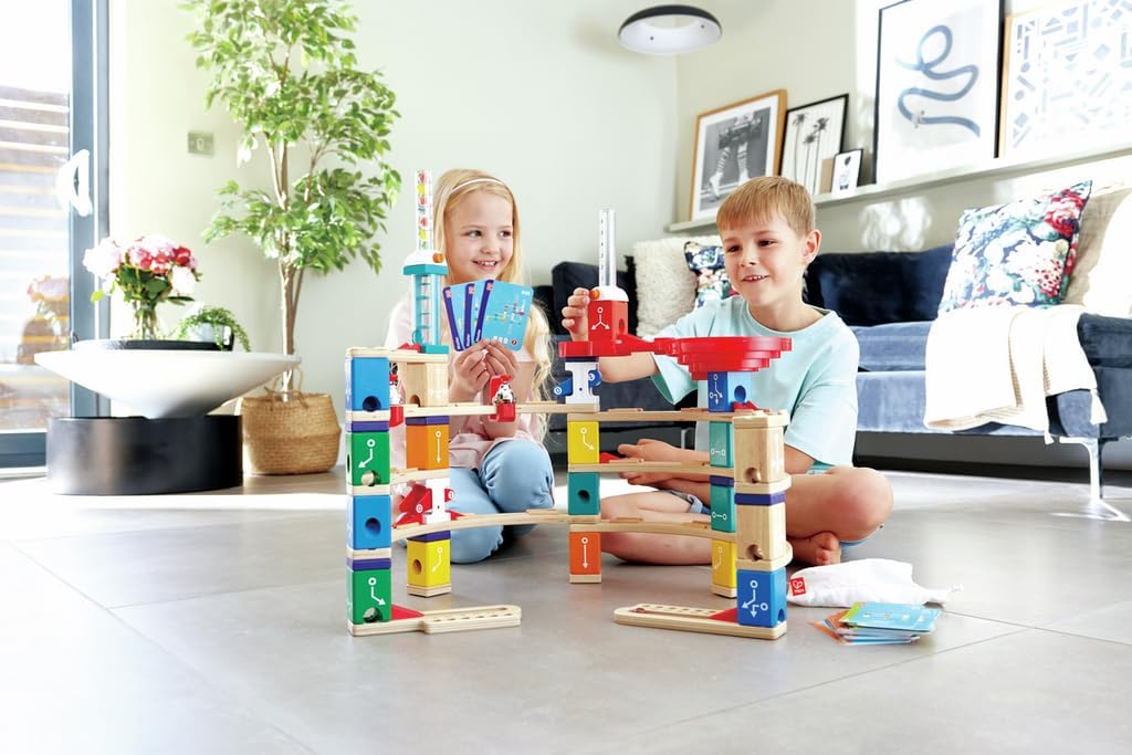 Quadrilla marble run set with colorful towers and wooden track pieces, children