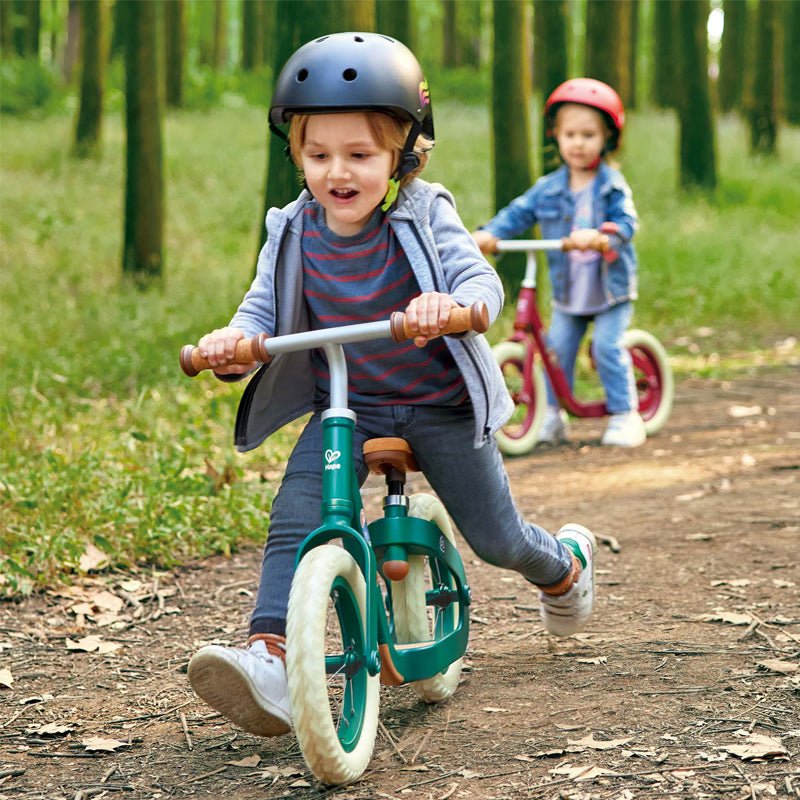 Kids black safety helmet on a bicycle, with straps and side vents visible