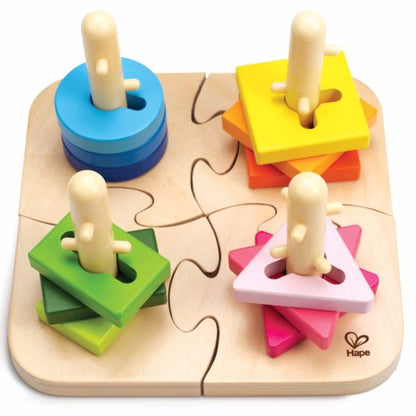 Wooden peg puzzle board with four colored blocks and light wood pegs