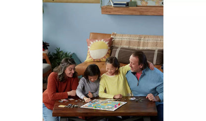 Family playing Monopoly Travel World Tour board game at a table with a map board