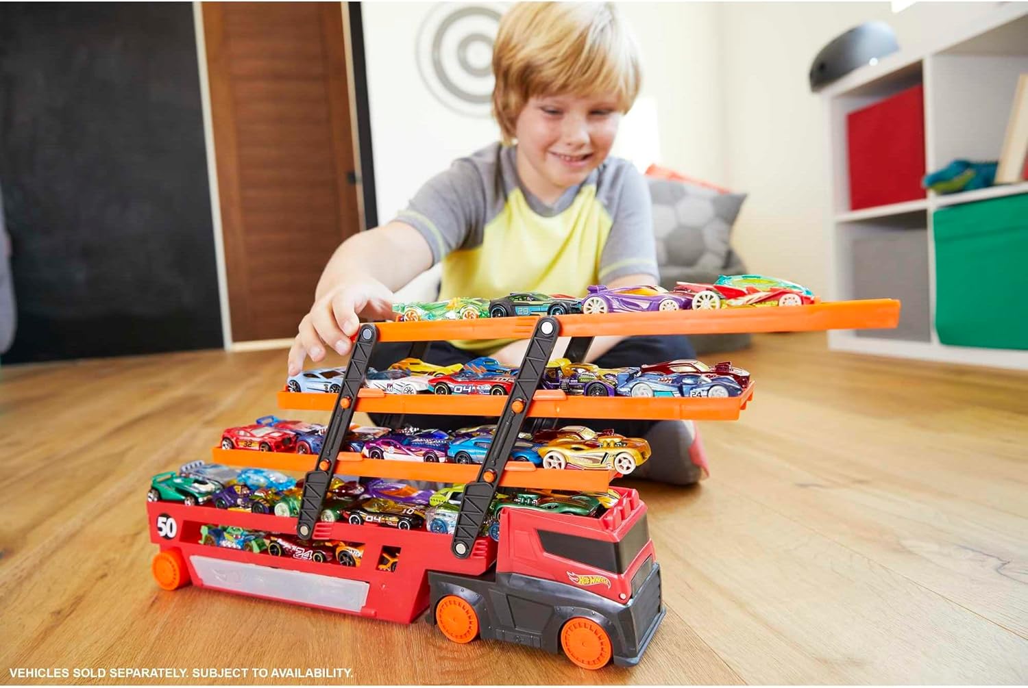 Toy car carrier truck in orange and red loaded with colorful die-cast cars