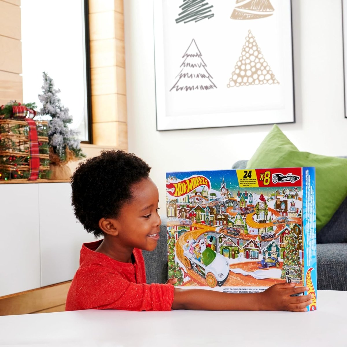 Toy car advent calendar box held by a child, front panel visible