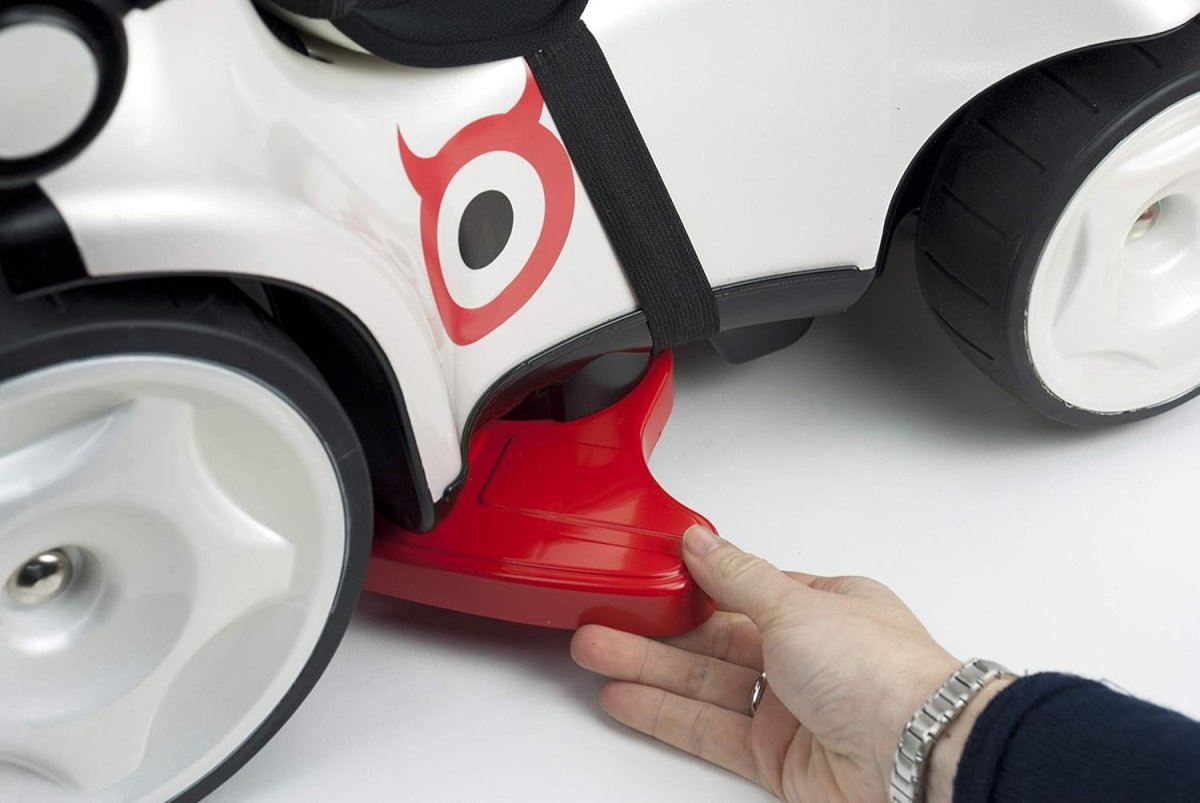 Kids ride-on push car red base with side panel, hand holding near front wheel