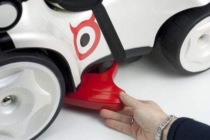 Kids ride-on push car red base with side panel, hand holding near front wheel