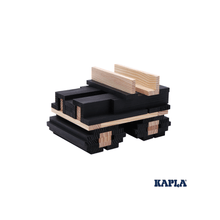 Square black wooden planks with light wood pieces stacked in a base