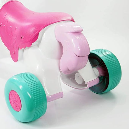 Ride-on unicorn toy side view, white body, teal wheels, pink mane and saddle