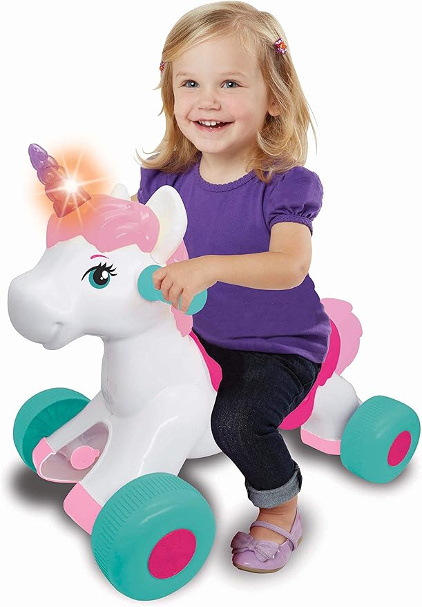 Ride-on unicorn toy with pink mane, teal wheels; child seated on saddle