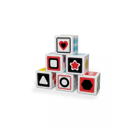 Stacked white wooden shape cubes with black symbols, red and blue accents