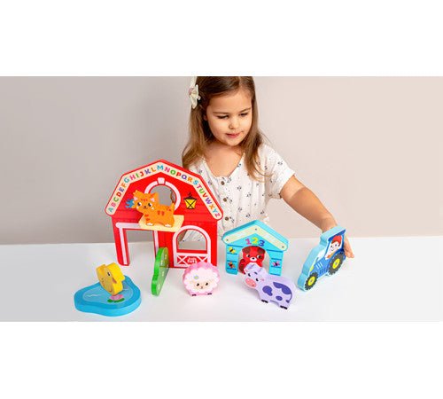 Wooden farm animal set with barn, toy animals, and number blocks on play table