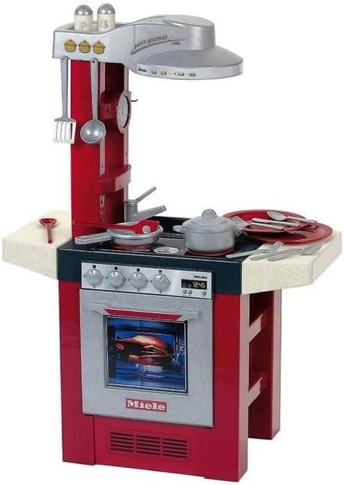 Miele toy kitchen set with red cabinet, oven door, stove burners, and cookware