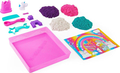 Sand sculpting kit pieces: molds, tools, pink tray, and multicolor sand