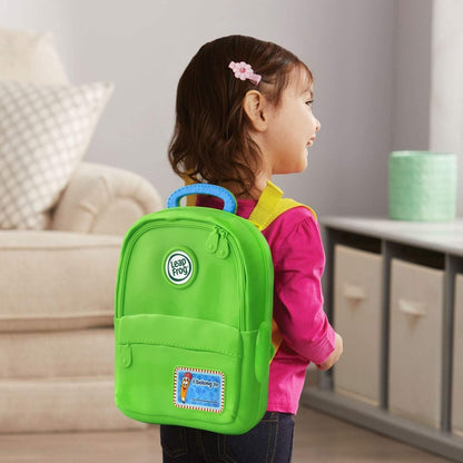 Green Alphabet backpack toy with handle and front panel, worn by child