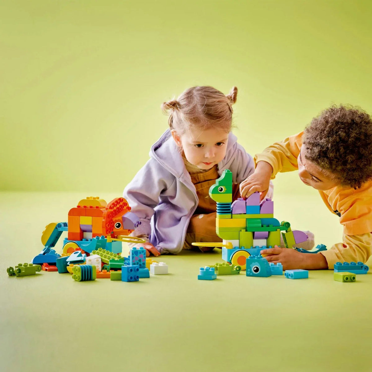 Dinosaur on wheels set with buildable dinos and loose bricks during play