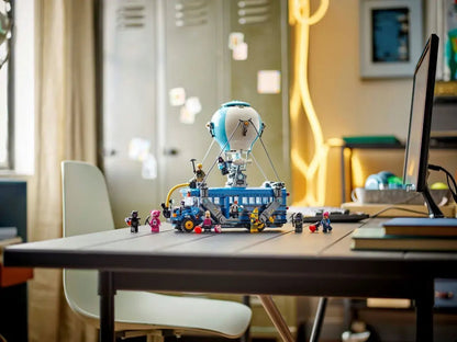 Battle Bus model on a desk with small minifigures and side turret