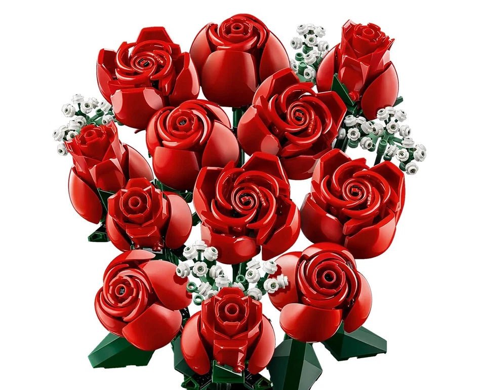 Red rose bouquet with green leaves and white tiny flower clusters