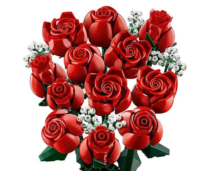 Red rose bouquet with green leaves and white tiny flower clusters