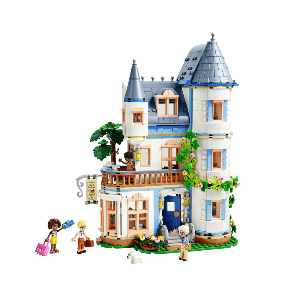 Blue-and-white LEGO castle with conical roofs, balconies, and garden flowers