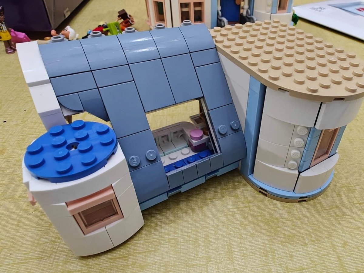 LEGO castle interior bay with blue tiled roof, window frame, and white outer walls