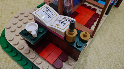 LEGO castle bedroom interior with red beds, tan floor, and small decorative pieces