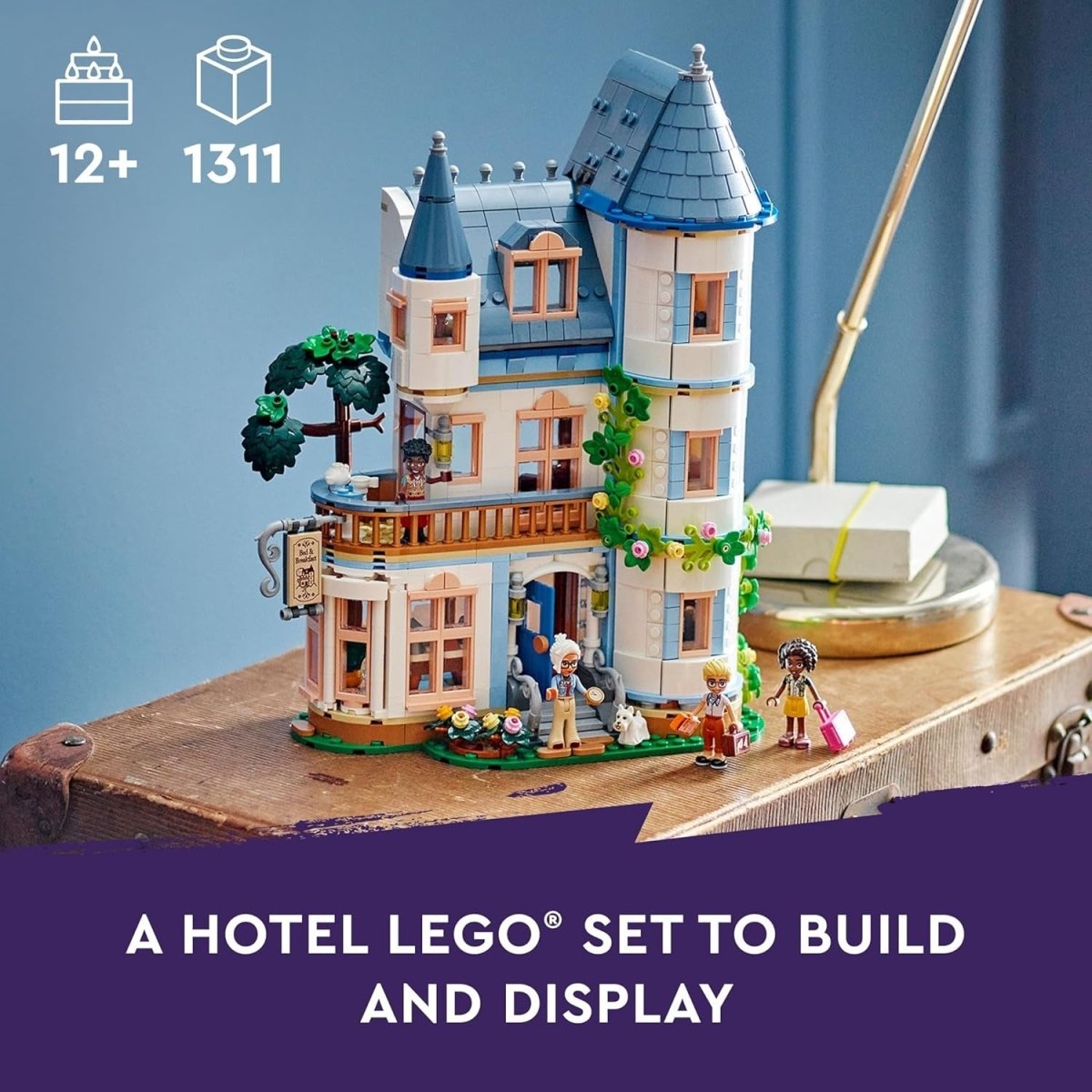 LEGO castle set on a wooden display base with minifigures and garden flowers