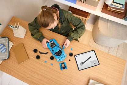 Corvette Stingray Blue LEGO model car being assembled on a wooden table