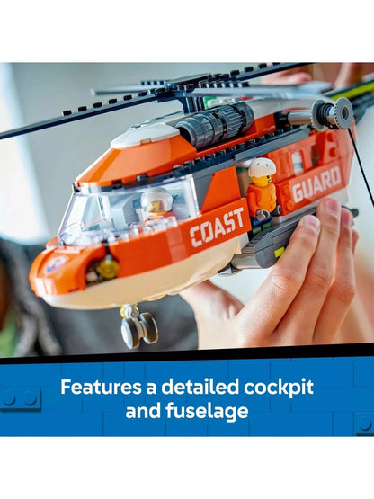 Detailed cockpit and fuselage of orange Coast Guard helicopter with seated figure