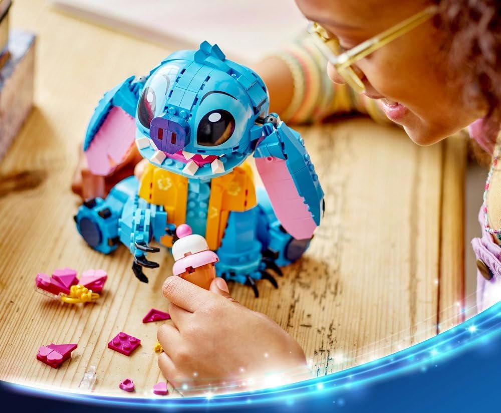 LEGO Stitch building toy being assembled by hand with small pink pieces