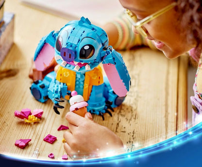 LEGO Stitch building toy being assembled by hand with small pink pieces