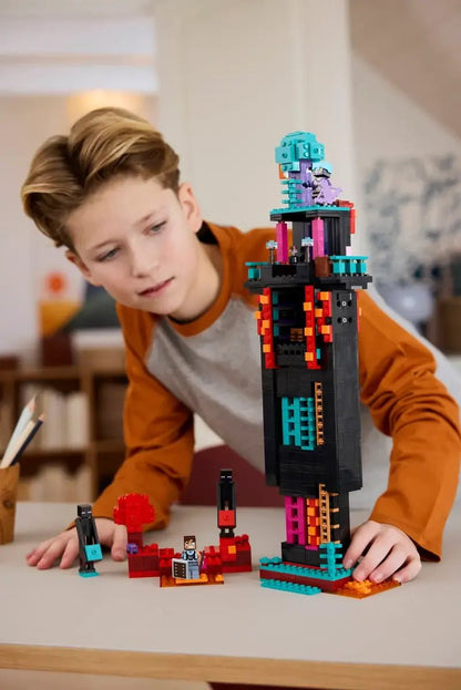 Child playing with Enderman Tower set, tall Enderman figure on orange and teal base