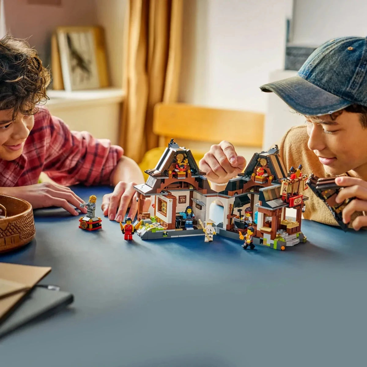 Children playing with the LEGO NINJAGO Four Weapons Blacksmith 15th Anniversary model
